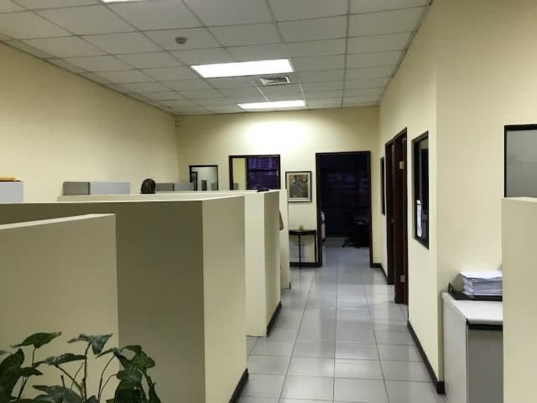 Commercial office reception area with glass doors, desk, blue chairs in PH Mall 50 Panama
