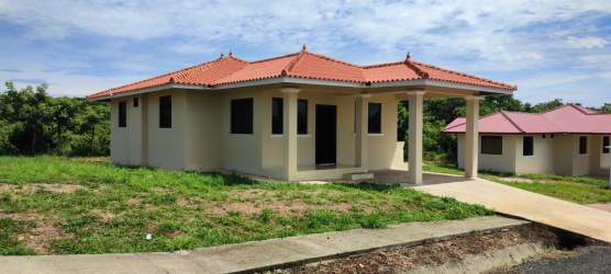 Front porch terrace of cream-colored bungalow new home in Bellas de Atalaya Santiago