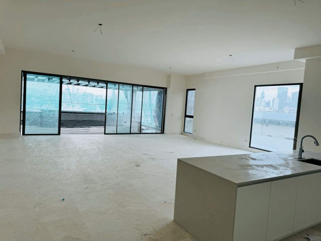 Open-concept unfinished apartment interior with floor-to-ceiling windows and panoramic marina views in Ocean Reef Island Panama