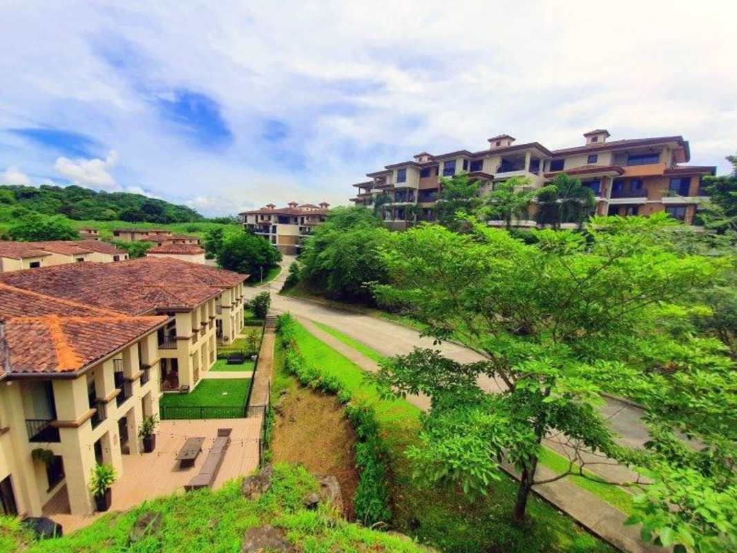 Multi-story Mediterranean residential buildings with lush tropical landscaping at Embassy Club Clayton Panama