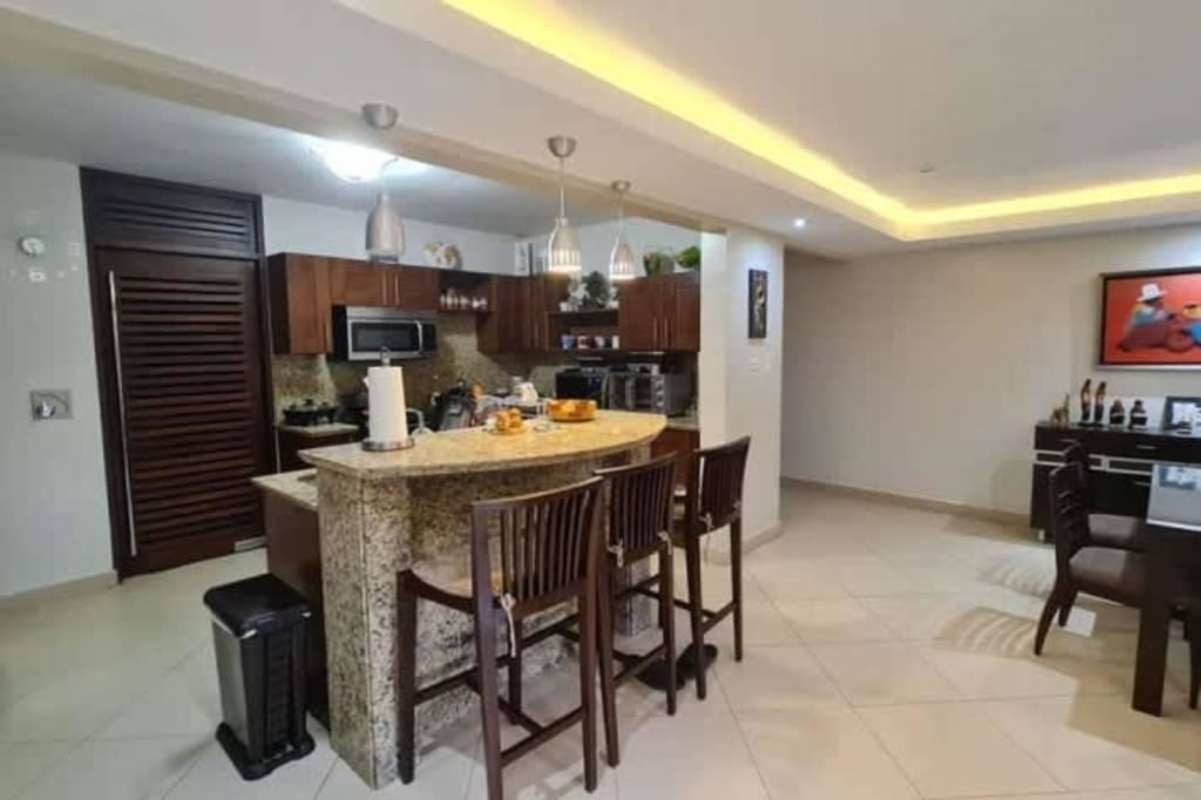 Contemporary kitchen granite countertops wooden cabinets at Embassy Club Clayton Panama