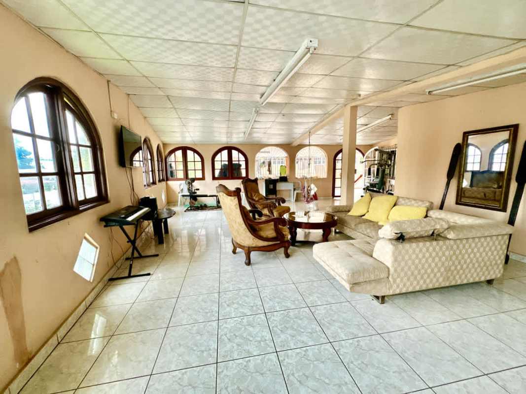 Bright living room with arched windows tiled floor in Campo Verde community Panama City