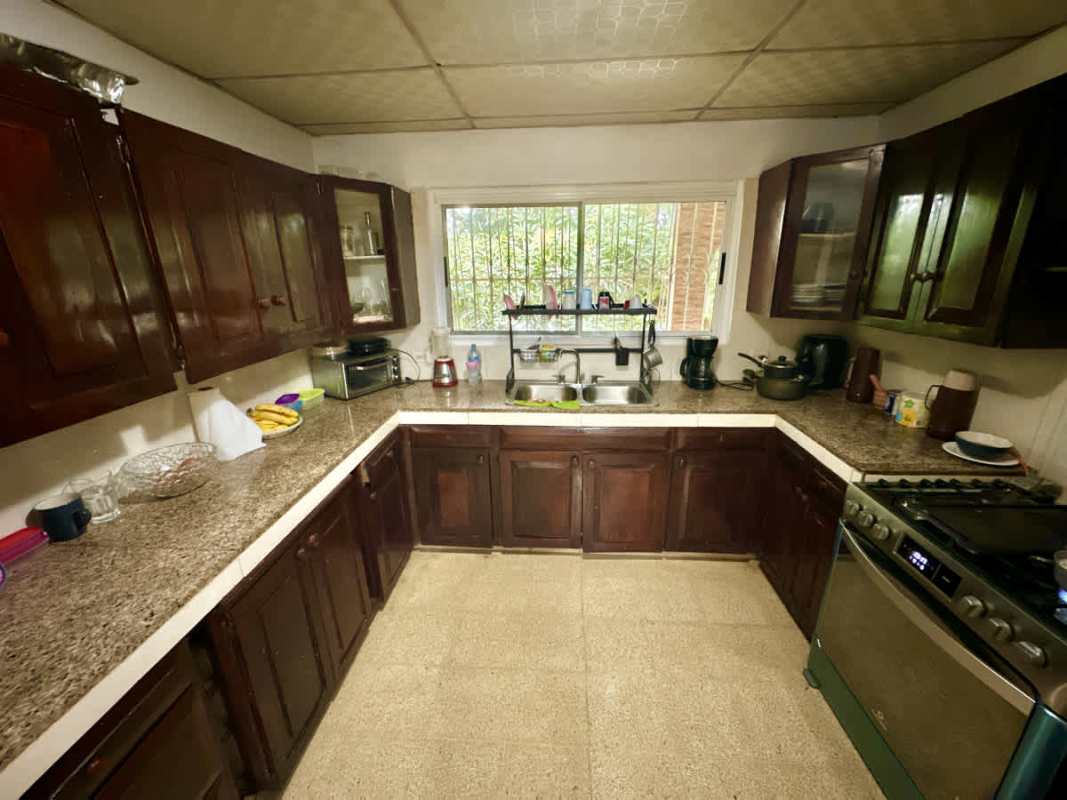 Traditional kitchen with wood cabinets U-shape granite counters appliances Campo Verde Panama