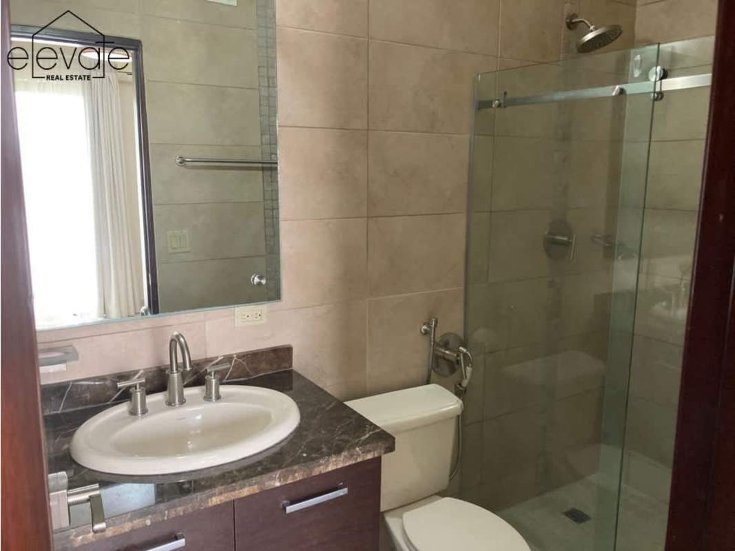 Kitchen with granite countertops, wood cabinetry in Embassy Village Clayton condo