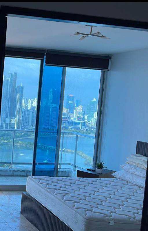 Elegant bedroom with floor-to-ceiling windows offering ocean and skyline views at PH Destiny Tower Panama City
