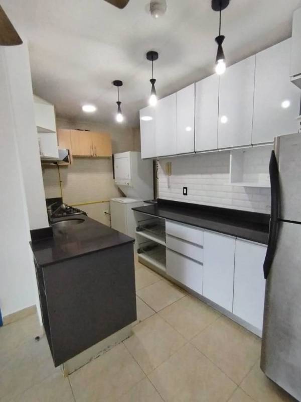 Remodeled kitchen with white cabinets, black countertop and appliances in PH Albrook Point, Clayton Panama