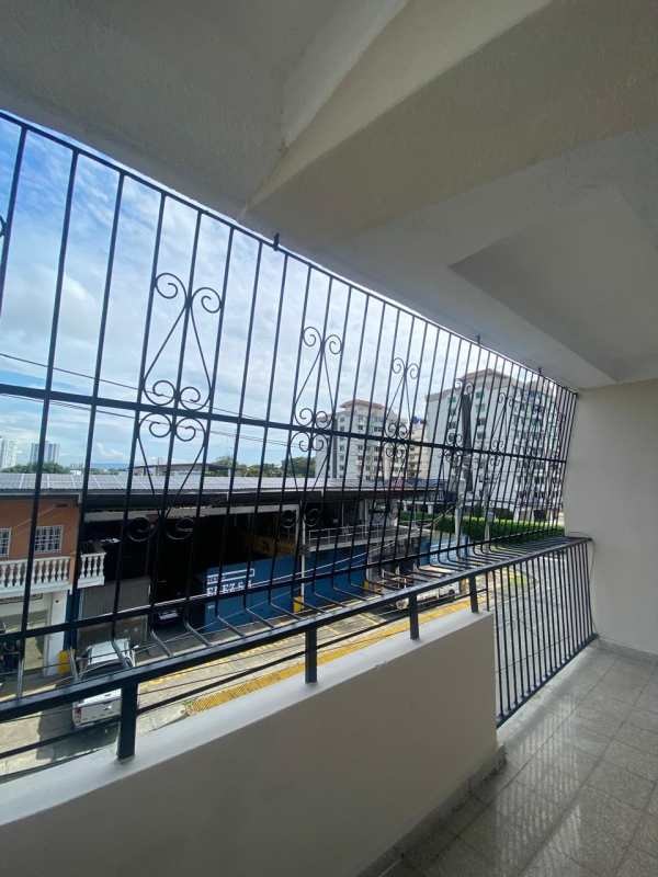 Covered balcony with iron grill overlooking street Edificio Dolores Panama