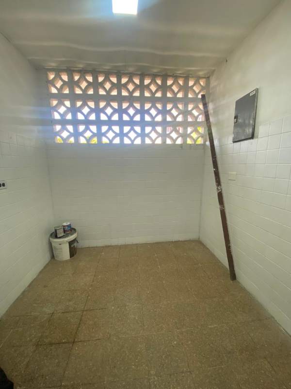 Functional laundry area with concrete sink and ventilation blocks in Parque Lefevre Panama