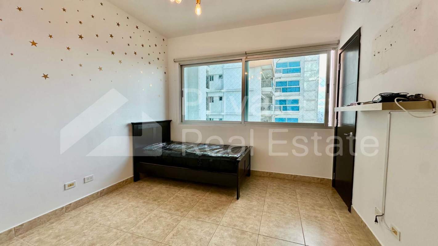 Bright living room with marble floors and large windows showcasing ocean view in PH Titanium Costa del Este