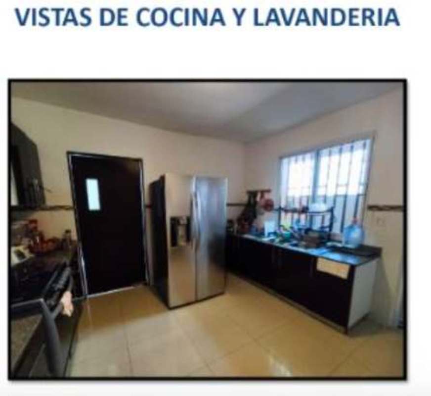 Spacious kitchen with granite countertops and adjacent laundry area in El Doral San Miguelito Panama