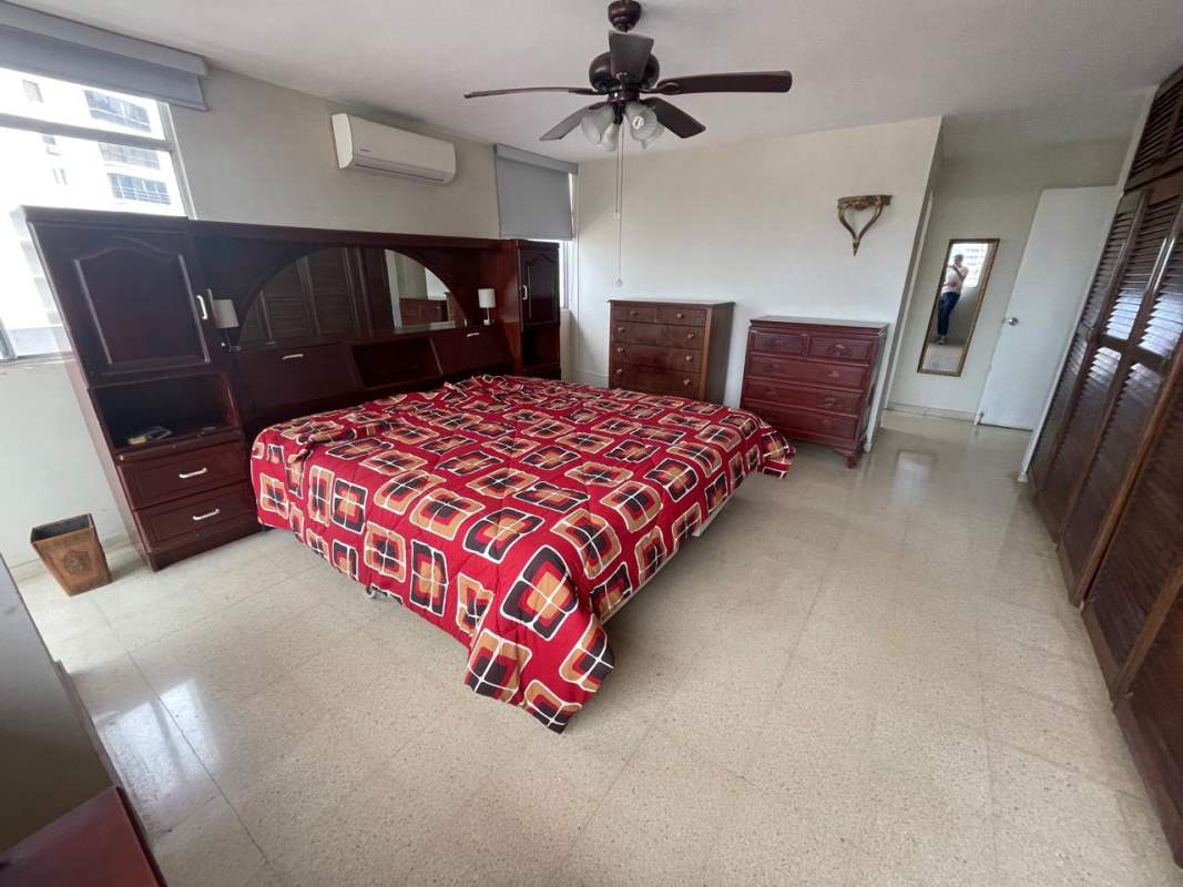 Living room with built-in wooden bar, ceiling fans, neutral tiles Punta Paitilla Panama