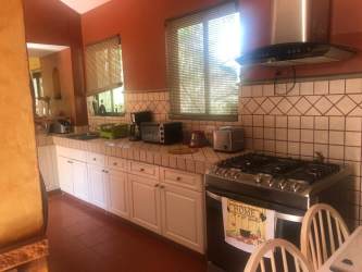 Spacious traditional kitchen granite countertops wood cabinetry in Buenaventura beach resort