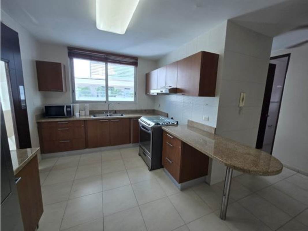 Kitchen with granite countertops, wooden cabinets in PH Soho Tower Costa del Este Panama