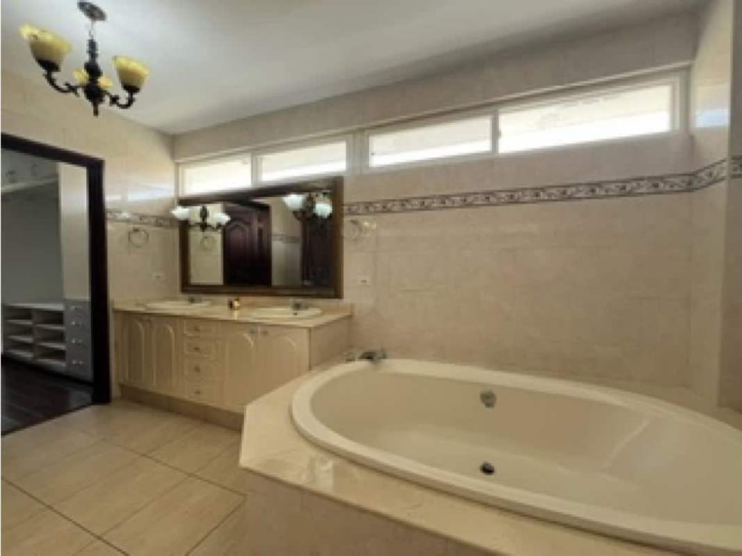 Half bath with marble counter, framed mirror and wood door PH Costa Dorada Panama City Panama