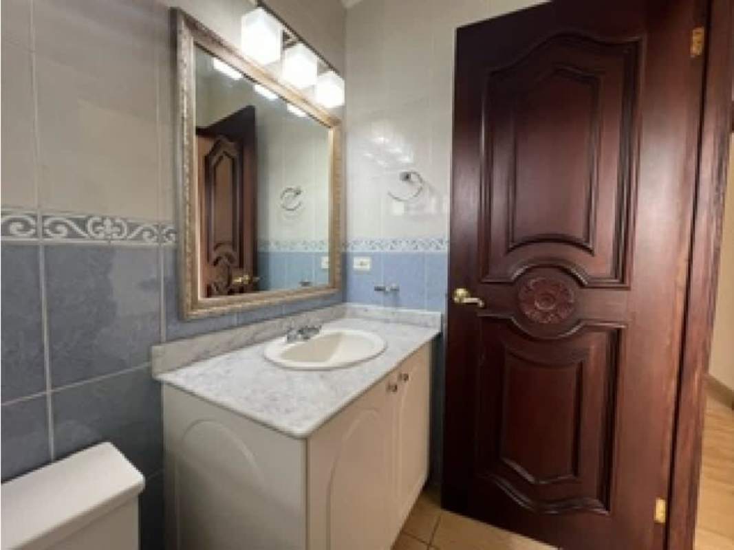 Bathroom with marble countertop, decorative tiles, wood door PH Costa Dorada luxury home Santa Maria Panama