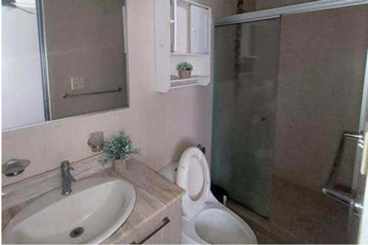 Contemporary bathroom with glass shower, vanity, mirror, apartment in PH Condado Gardens Panama