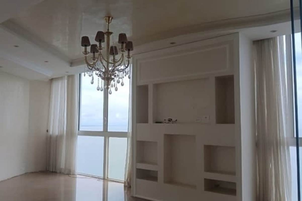 Spa-style bathroom with double sinks, marble tiles, large soaking tub overlooking ocean Punta Pacífica