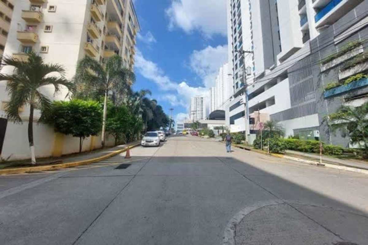 City street view with high-rise condos palm trees PH Condado Country Club Panama