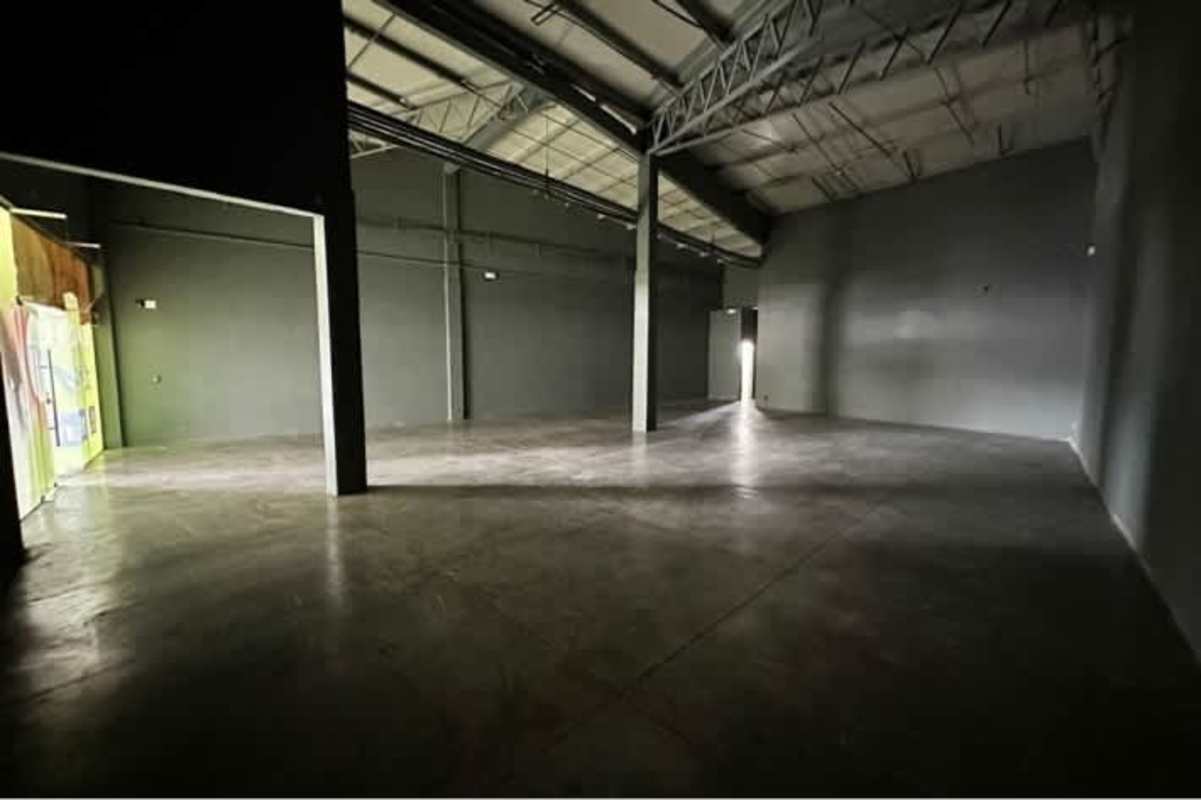 Empty spacious warehouse with concrete floor and high ceiling in retail center Panama