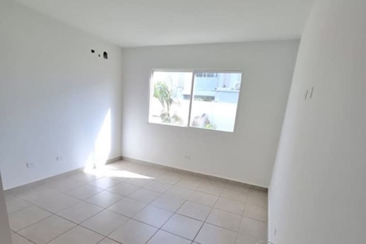 Empty minimalist bedroom with tile flooring and large windows in Panama