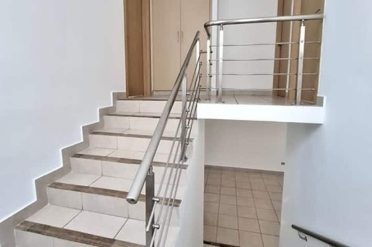 Unfurnished bedroom with tile floors bright window and minimalist styling