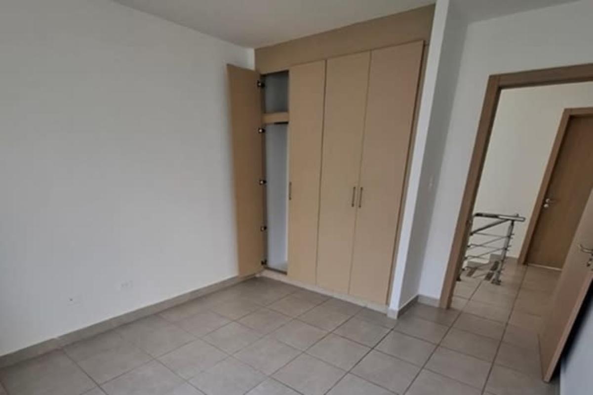 Bedroom with built-in sliding wardrobes in family home Panama