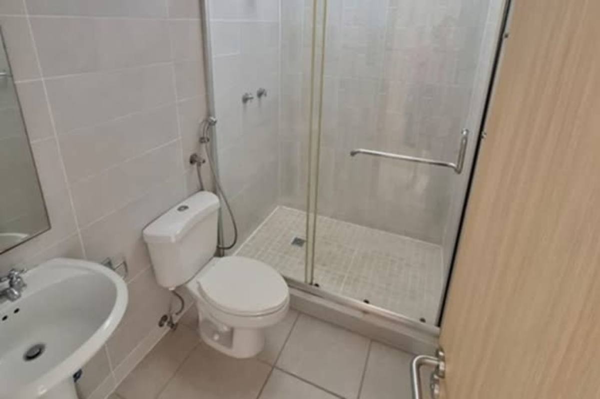 Compact bathroom with glass shower and white fixtures in Panama house