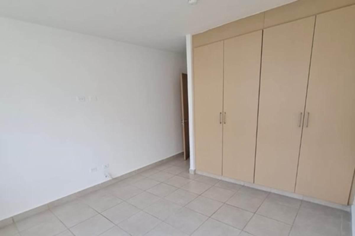 Walk-in closet with built-in storage dresser inside house in Paseo del Norte