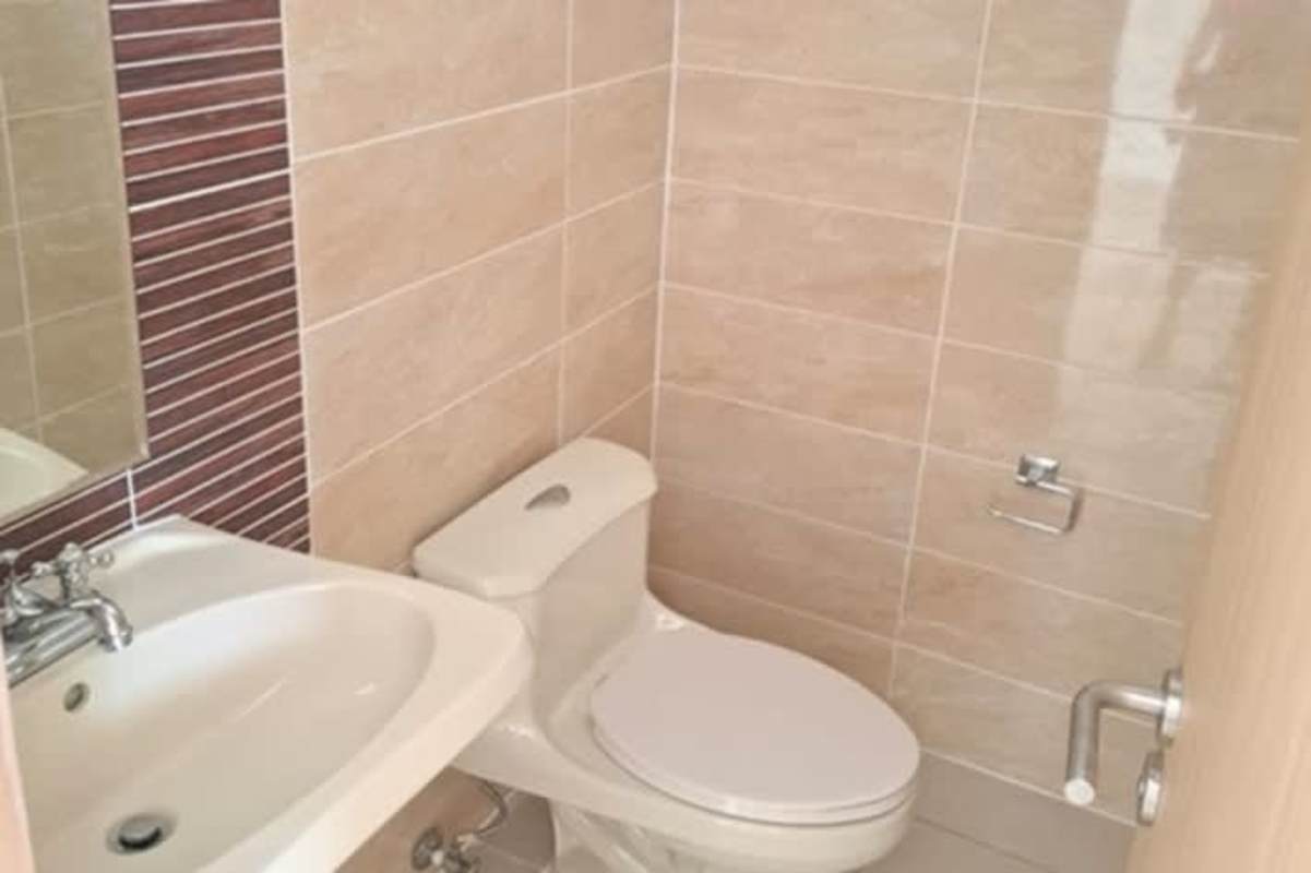 Small minimalist bathroom with glass shower beige tiles in Panama house