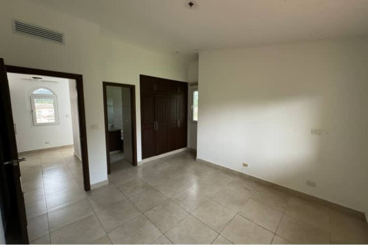 Luxury open living dining room with large windows in golf course house Ancon Panama