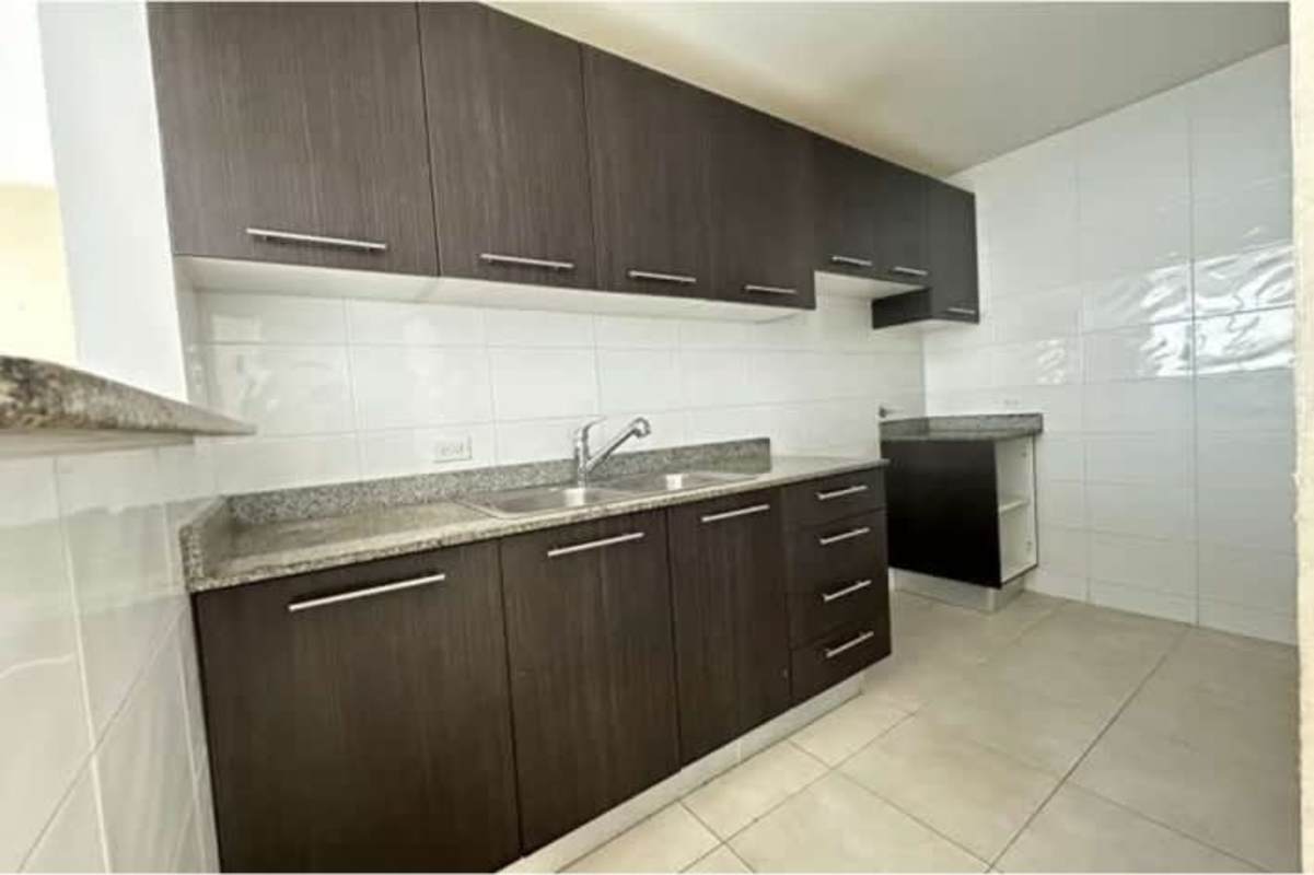 Kitchen featuring granite countertop, cabinetry and pass-through window in PH Nuevo Betania Panama