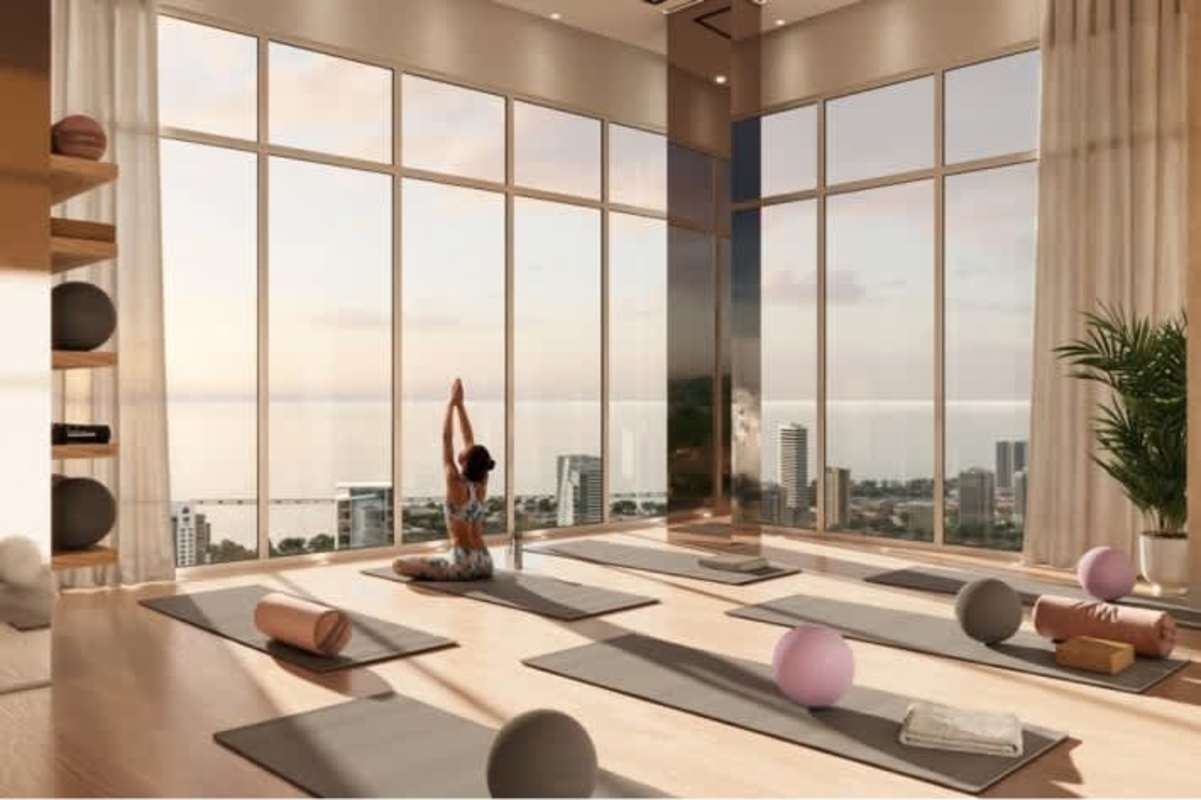 Yoga studio with floor-to-ceiling windows city skyline ocean views at PH Costanera Torre Aqua Panama