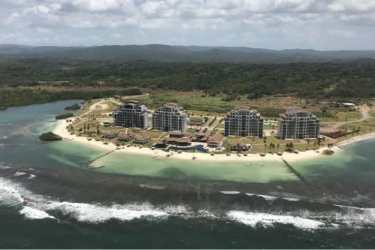 Bright living room with large windows ocean views balcony Playa Escondida Resort Portobelo Panama