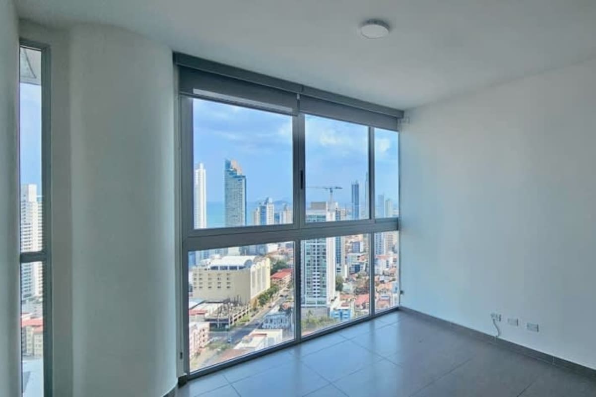 Modern minimalist bedroom with large window and mountain view, built-in wardrobe, PH Signature Point Panama City