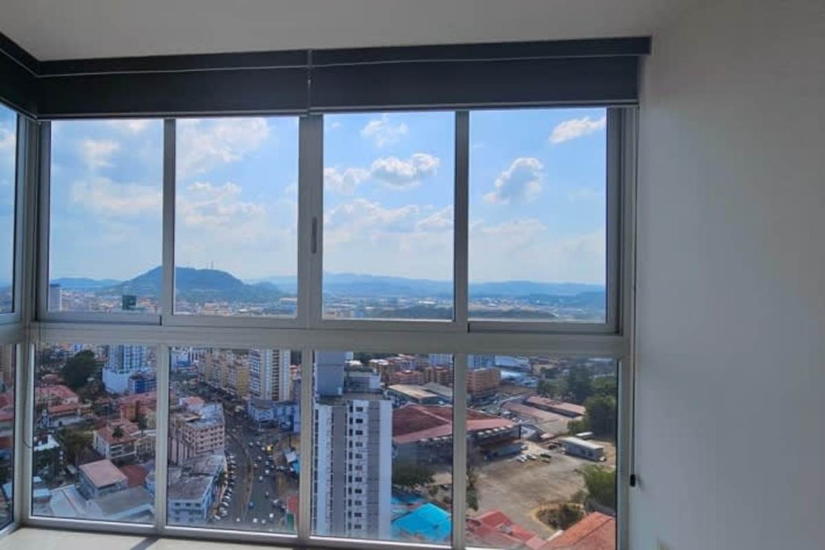 Modern kitchen with granite countertops, gray backsplash and window at PH Signature Point Panama City