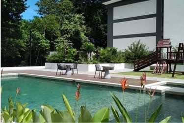 Poolside tropical garden and children’s playset in Costa Verde The District development