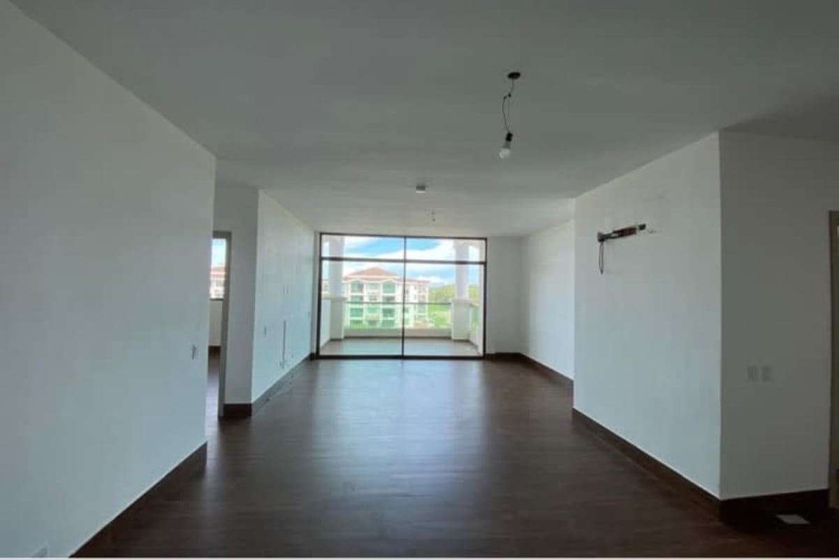 Bright living dining area with large windows tile floors Costa Sur apartment