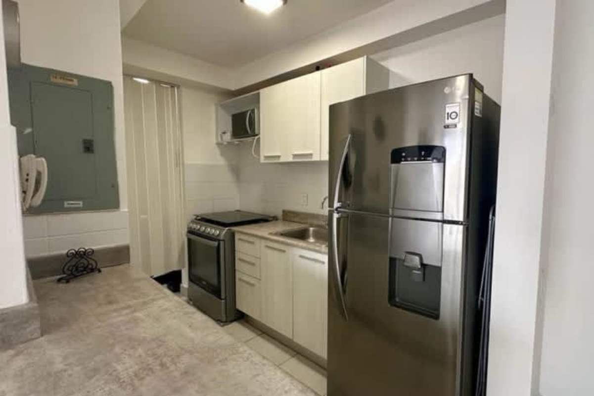 Kitchen with refrigerator, stove, microwave white cabinets tile PH ILO Panama