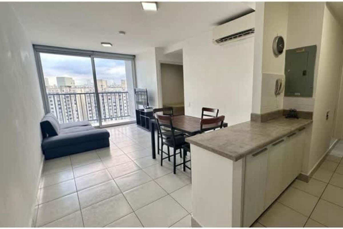 Open concept living and dining room with sliding doors to balcony in PH ILO Panama