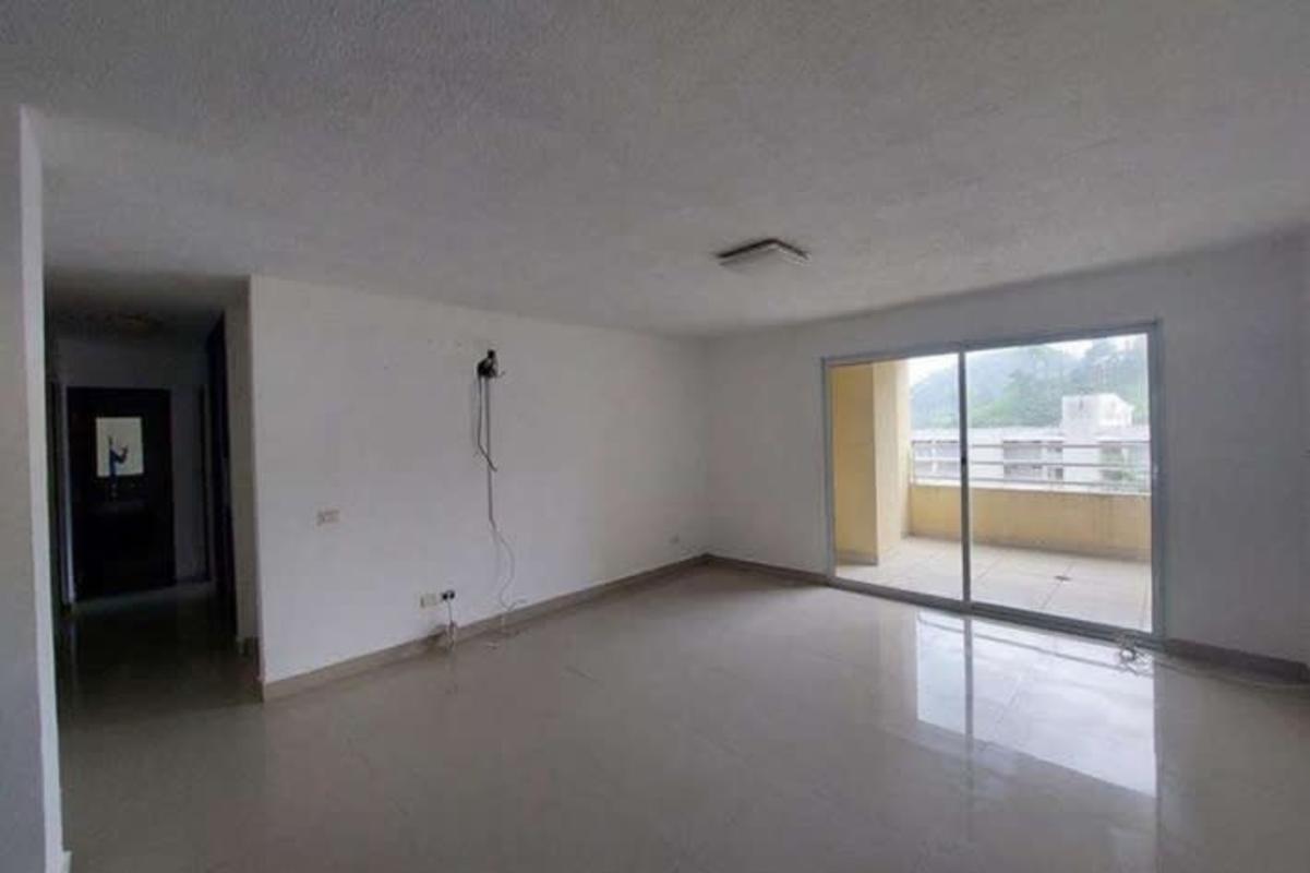 Modern apartment complex with parking lot and palm landscaping in Ancón Panama