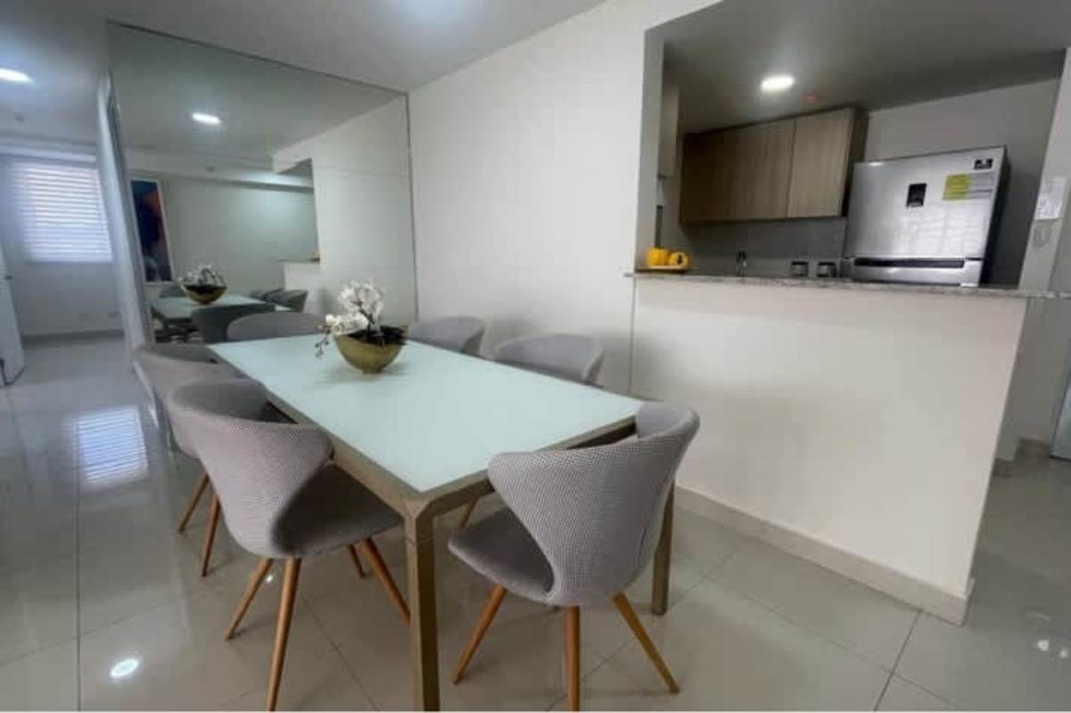 Kitchen area with granite counter, wood cabinets, appliances in PH Condado Plaza Condado del Rey Panama