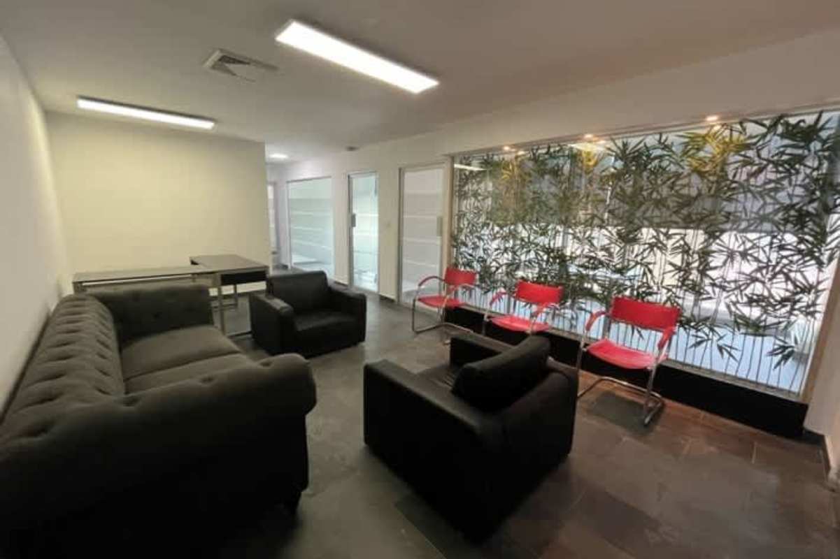 Bright modern reception area with glass wall, sofas and waiting chairs in PH BICSA Tower Panama City