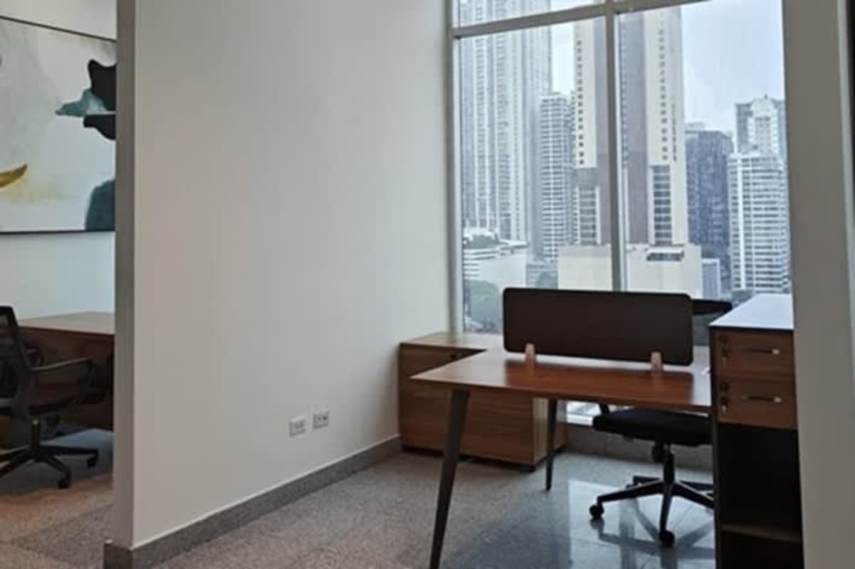 Desk setup by large window with skyline view PH BICSA Tower Obarrio Panama