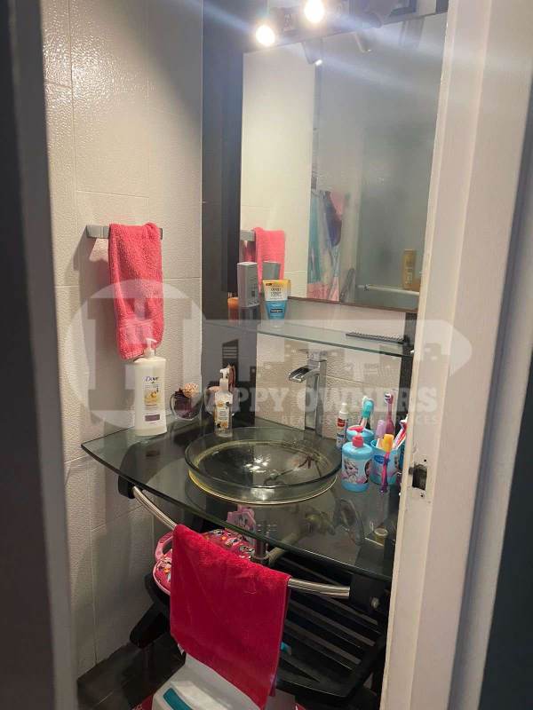 Contemporary kitchen with granite countertops and red cabinetry at PH Royal Princess Punta Paitilla Panama