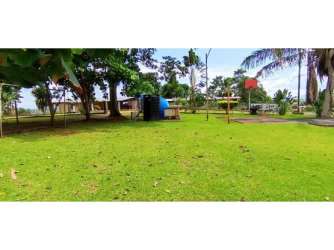 Large outdoor pool with jacuzzi surrounded by garden and seating in La Chorrera countryside estate
