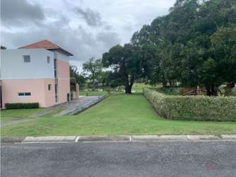 Two-story pink villa with large lawn and tropical trees in Villas de Decameron Río Hato Panama