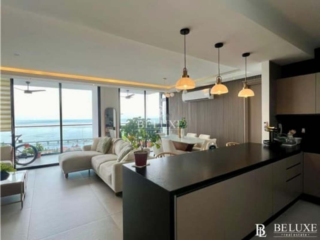 Contemporary kitchen with black countertops, beige cabinetry in PH Victory Wellness Panama
