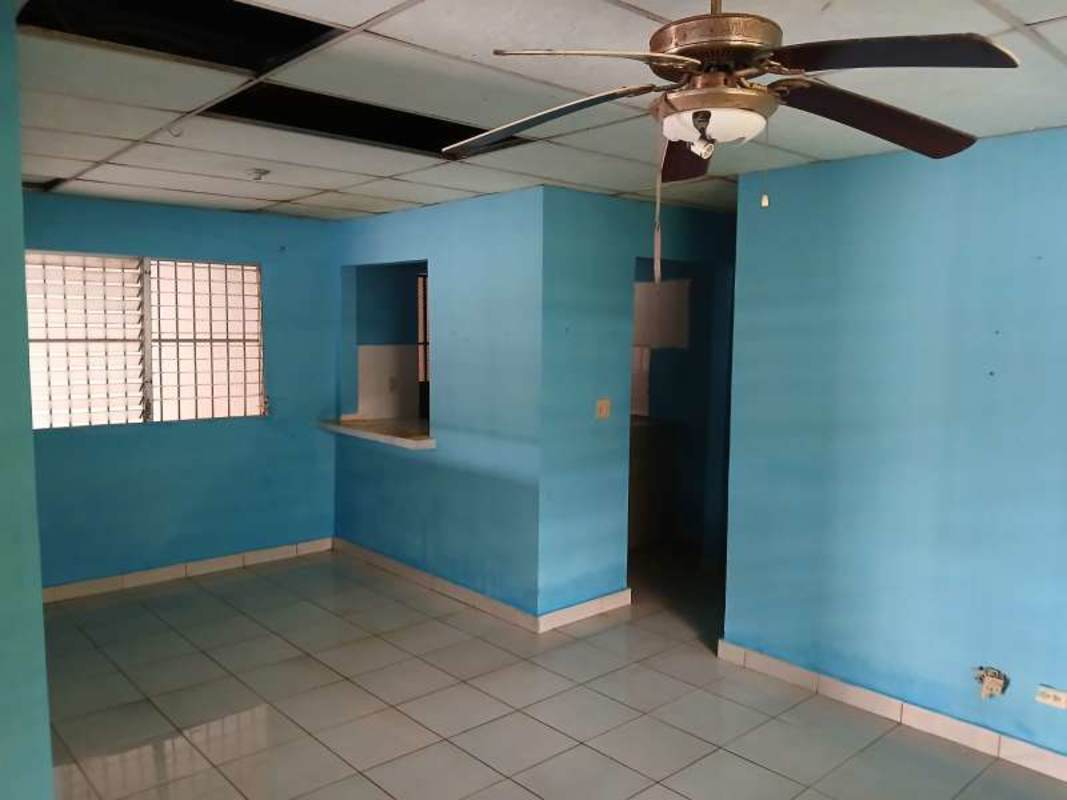 Living dining space with blue walls, tiled floor, ceiling fan, pass-through to kitchen La Providencia Las Cumbres