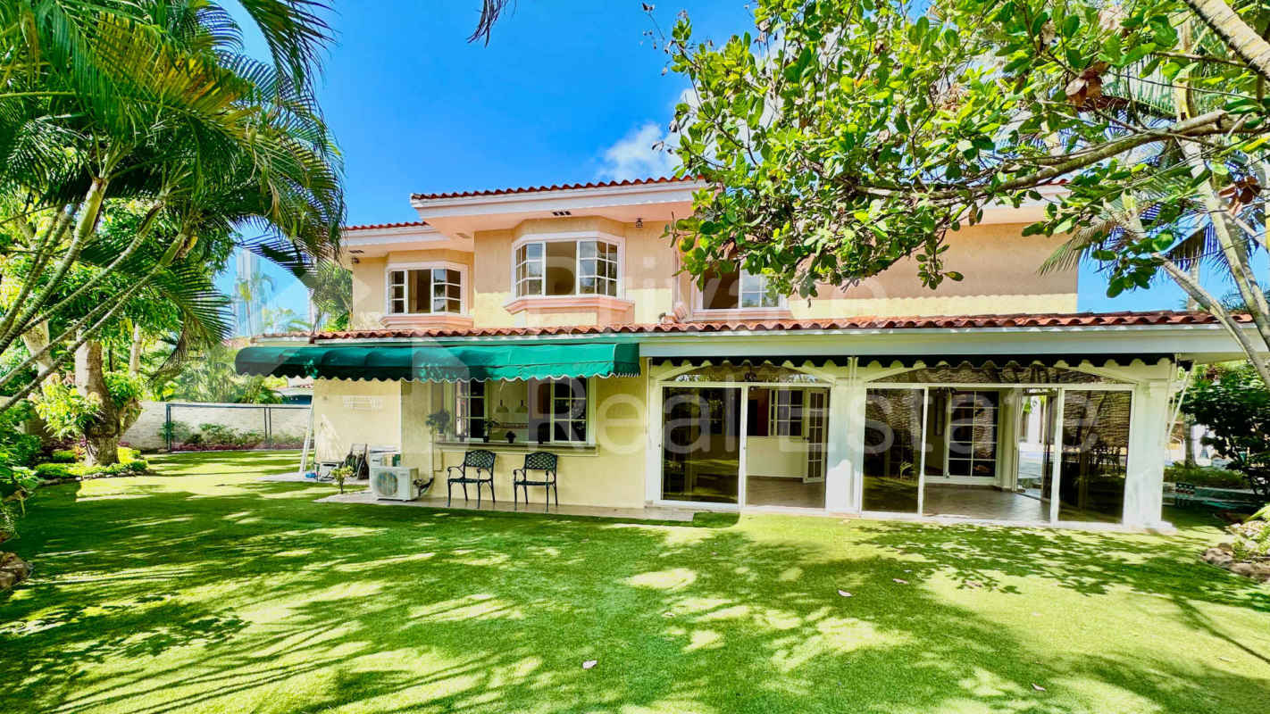 Two-story luxury house with tiled roof, tropical landscaping and pool Costa Serena Panama