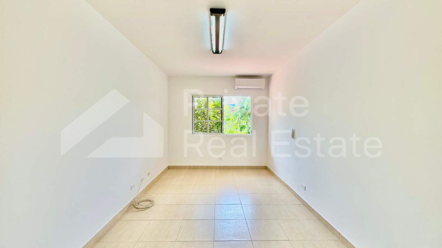 Large living area with staircase, tile floors, and natural light in Costa Serena house Panama City